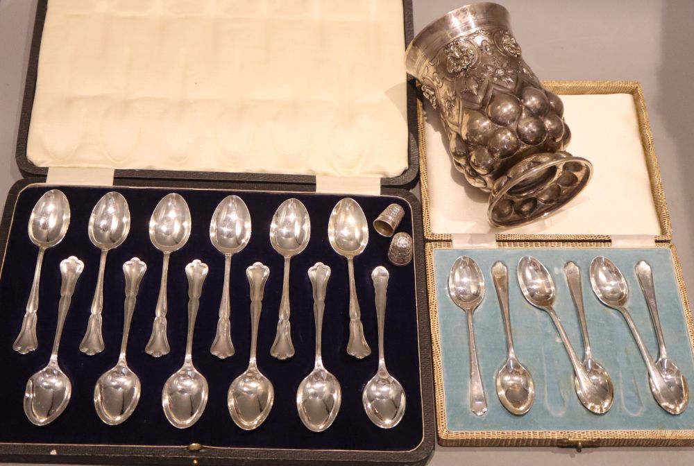 A cased set of eleven George V silver teaspoons and one other matched teaspoon, 1 other cased set and three other items.